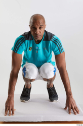 Whole Body Man Black Sports Shirt Shorts Slim Kneeling Studio photo references